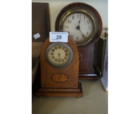 An Edwardian inlaid mahogany balloon shaped mantel clock with three further mantel clocks.