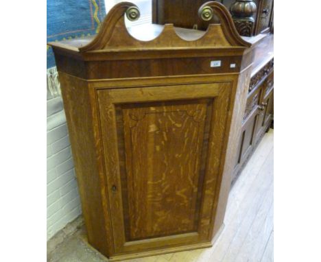 A Georgian light oak flat fronted corner cupboard.