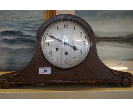 An early 20th Century oak cased Napoleon's hat mantel clock, bears presentation plaque.