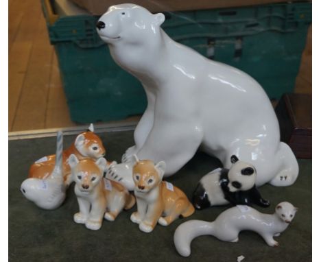 A collection of seven Russian ceramic animals to include three cubs, panda, bird, ferret and a large fireside polar bear.