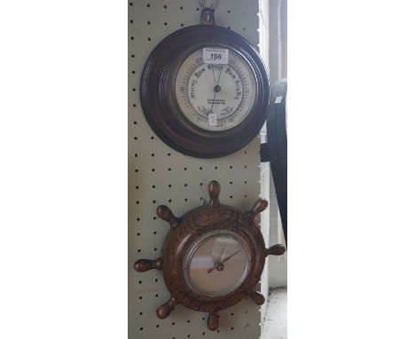 An early 20th Century oak framed aneroid barometer retailed by Armstrongs of Manchester, together with a similar later exampl