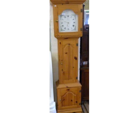 A reproduction pine tempus fugit longcase clock.