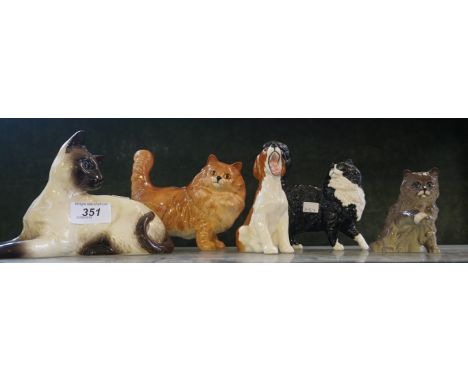 A group of four ceramic cat models to include two Beswick and two Royal Doulton examples together with a Beswick model of a b