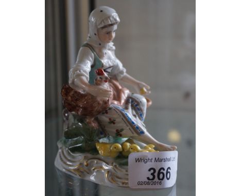 A Dresden ceramic model of a girl feeding a cockerel.