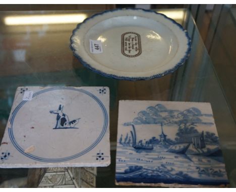 Two early ceramic tiles one depicting a seated dog and the other depicting an oriental fishing landscape together with a furt