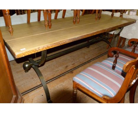 A contemporary light soft wood panelled top refectory table, raised on a metal support.