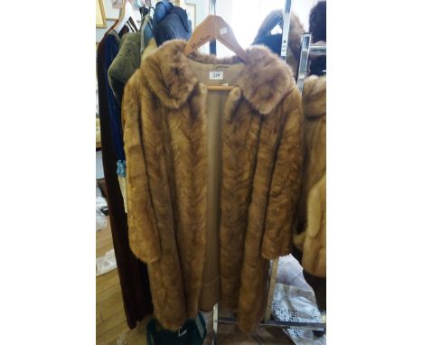 A Ladies light brown mink fur coat, long length, the fur in chevron design, camel colour silk lining 