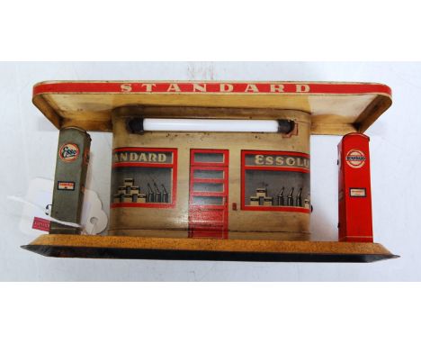 A tinplate Standard Petrol garage fitted with battery operation to power light fitting, comprising red, cream and grey tin pr