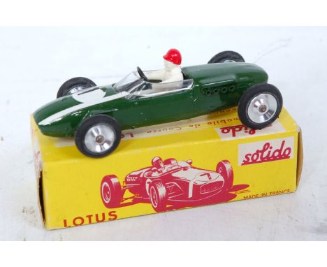 A Solido No. 118 Lotus F1 racing car comprising green body with racing No. 1 and chrome hubs with driver figure, in the origi