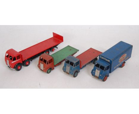 Four various loose playworn Dinky Toy commercial vehicles to include an Eveready guy van, two No. 512 guy flat trucks, togeth