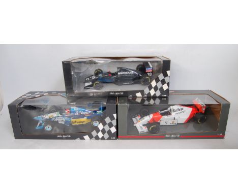 Three various boxed Minichamps 1/18 scale F1 racing diecasts, to include a Maclaren Peugeot MP4/9 Mika Hakkinen 1994, an HH F
