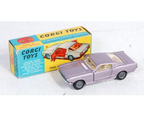 Corgi Toys, 320 Ford Mustang Fastback 2+2, metallic purple body with cream interior, wire work hubs, in the original blue and