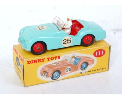 A Dinky Toys No. 111 Triumph TR2 sports car comprising turquoise body with red interior and red hubs, with driver figure and 