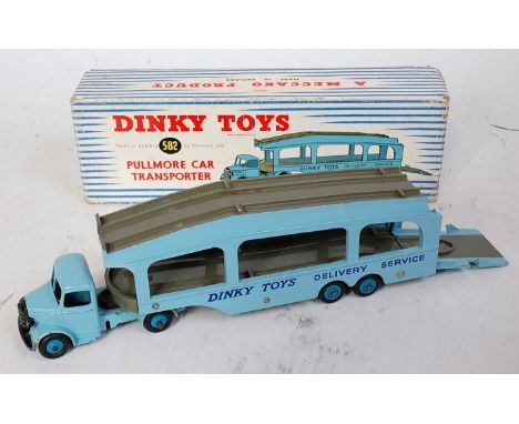A Dinky Toys No. 582 Pull More Car Transporter comprising light blue cab and back with grey decks, with dark blue hubs, 6 riv