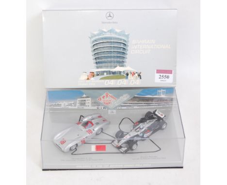 A Minichamps 1/43 scale model Mercedes Benz W196/Maclaren Formula One Bahrain Grand Prix 2004 box set, limited edition exampl