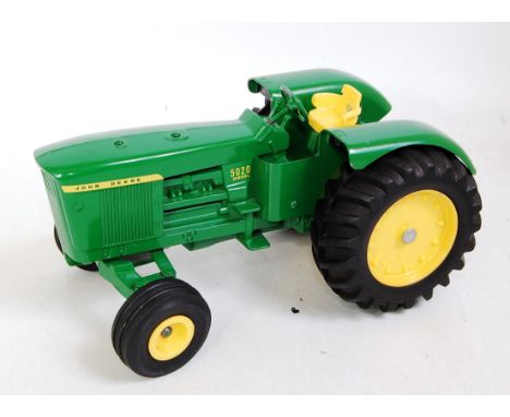 Three various mixed scale Ertl John Deere farming diecast to include a John Deere Model D tractor, a John Deere No. 5020 dies