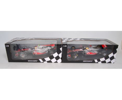 A Minichamps box 1/18 scale boxed F1 racing car group to include a Vodafone Maclaren Mercedes MP4-25 Lewis Hamilton 2010, tog