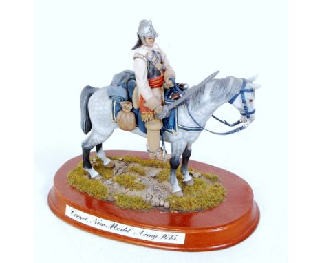 A very well cast and hand painted model of a Cornet New Model Army 1645 mounted officer, all housed on wooden display plinth 