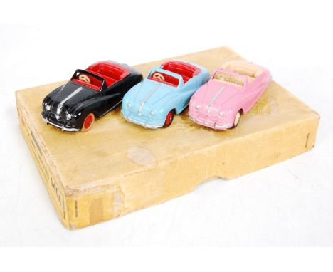 A Dinky Toys No. 140A Austin Atlantic Convertible trade box containing three various examples, one finished in pink and cream