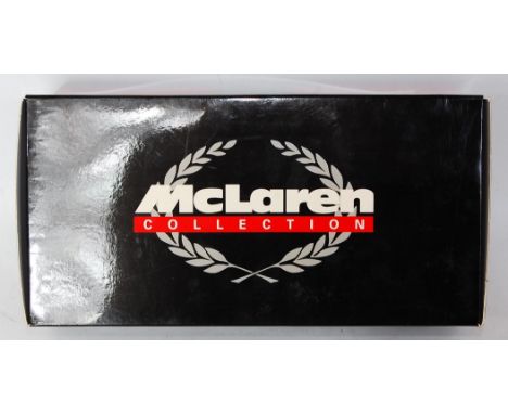 A Minichamps 1/18 scale Maclaren collection model of a Maclaren Ford M23 British Grand Prix 1977 G Villeneuve, all housed in 