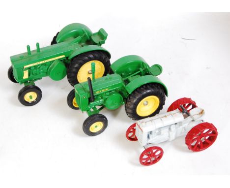 Three various loose Ertl heavy metal diecast tractors examples to include John Deere diesel 820, a John Deere D-type tractor,