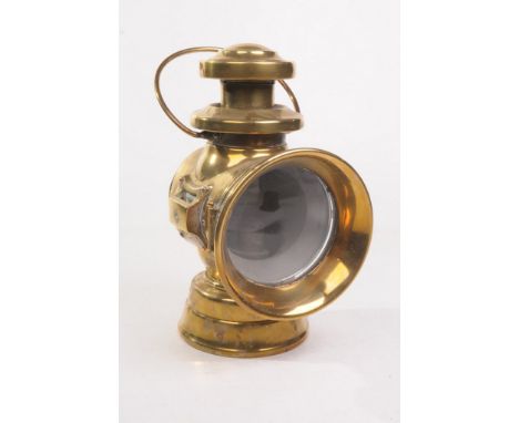 A Lucas 'King of the Road' oil side lamp
Of polished brass with an applied copper manufacturers plaque 30cm high. (illustrate