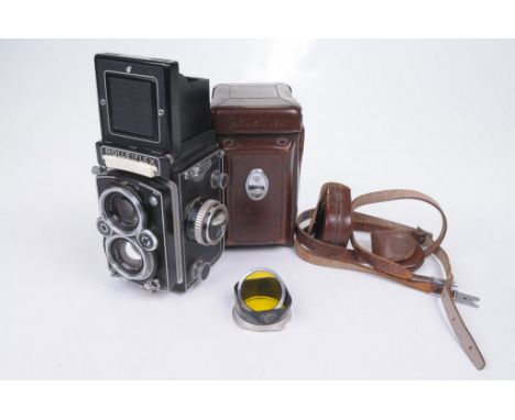 A Rolleiflex Camera
With a Zeiss Planar 1.305F 75mm lens complete with carry strap, yellow diffuser and lens hood.  (illustra