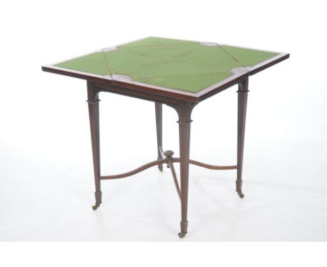 An Edwardian inlaid mahogany envelope games table
The inlaid and satinwood crossbanded folding top enclosing a green baize pl