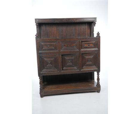 A 17th Century and later oak Flemish court cupboard
The raised back with a plain frieze above two sphere and acorn shaped fin
