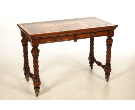 A Victorian walnut ladies Gothic revival writing table, by Hindley & Sons of London
The rectangular top inset with a tan leat