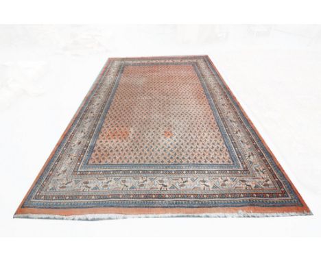 A North West Persian carpet
The red ground with guard stripes with a frieze of stylised flowers and leaves, the central groun