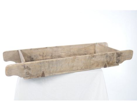 A Vintage wooden cattle trough
The wooden plank trough with extended handles and metal bound sections, 163cms long, 67cms wid