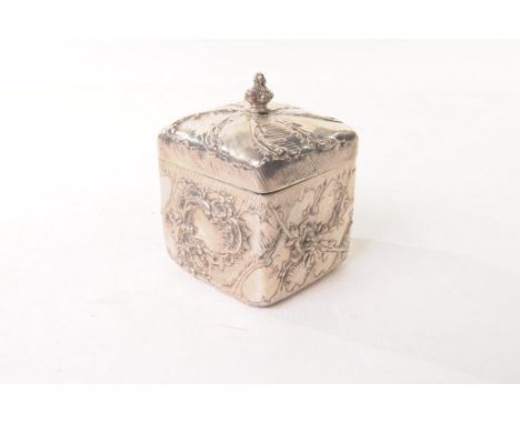 A 19th century German white metal tea caddy
Of cubic form, the knopped scroll finial to a pull of lid, profusely engraved and