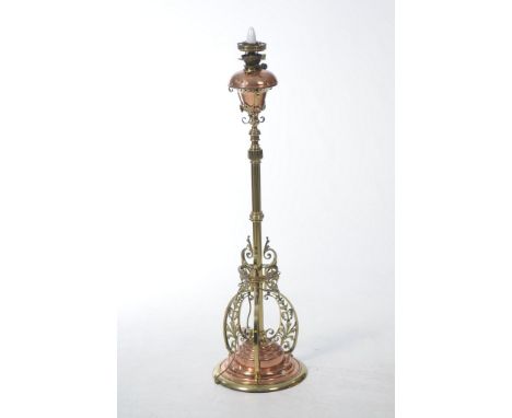 A large copper and brass standard oil lamp
The stepped circular base applied with three scalloped and pierced sections, the s
