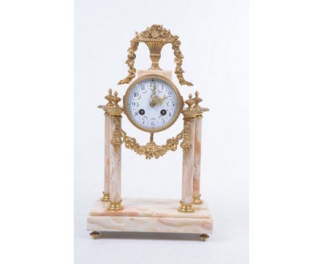 A late 19th Century onyx and gilt metal mantle clock
The flat plinth base raised on gilded terminals, extending to four colum