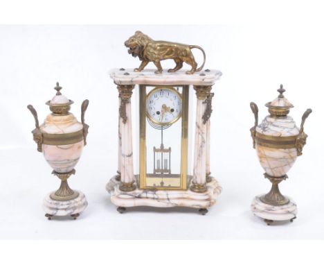 A late 19th Century French ormulu and marble clock garniture
The architectural mantle clock with Corinthian columns extending