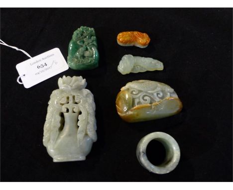 A collection of six jade items, including a ring, and jade carvings.