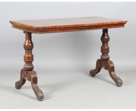 A Regency mahogany rectangular centre table, in the manner of Gillows, the turned twin supports raised on fluted downswept le