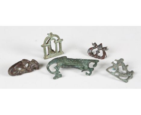 A group of five Roman and other ancient copper alloy brooches, including fighting gladiators, a galley, a hound attacking a h