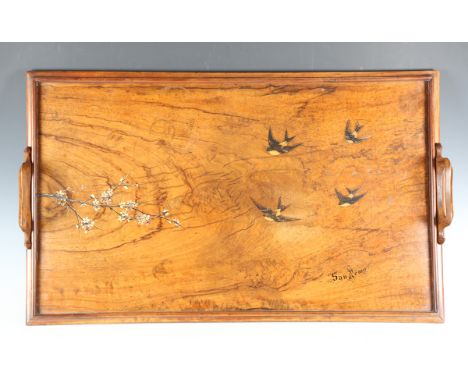 An Italian olivewood tea tray, inlaid with four swallows and painted with a blossoming branch, inscribed 'San Remo', width 81
