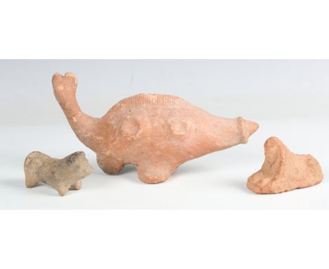 A Roman period Egyptian terracotta model of a sphinx, 1st century AD, length 7cm, together with a solid-modelled red slip pot