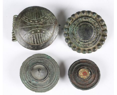 A group of four large ancient copper alloy disc and boss type brooches, including an example with millefiori enamel type deco