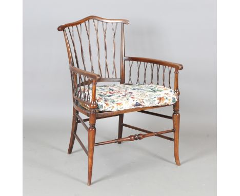 An early 20th century Arts and Crafts stick back elbow chair with a caned seat, height 83cm, width 56cm, depth 56cm. Provenan