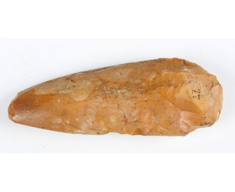 A Neolithic polished flint axe of typical tapering form, detailed in black ink 'Wittering West Sussex', length 15cm. Provenan
