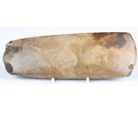 A Danish Neolithic polished stone axehead of yellow-brown flint, bearing old collection label detailed '179', length 21cm. Pr