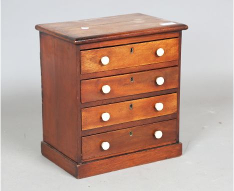 A Victorian mahogany table-top collector's chest of drawers with applied ivory handles, height 35cm, width 32cm, depth 23cm. 