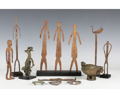 A Bambara wrought iron female figure, Mali, height 19cm, together with a small group of other similar figures, an iron staff 