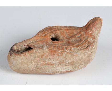 A Byzantine terracotta oil lamp, the top decorated in relief with a Chi Rho, length 9.5cm.Buyer’s Premium 29.4% (including VA