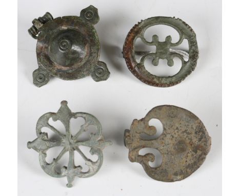 A group of four Roman plate type brooches, including a raised umbonate disc type, width 4.5cm, a military type pelta brooch w