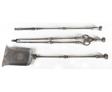 A set of three George III steel fire tools with octagonal facet handles and turned shafts, length of shovel 76cm. Provenance: